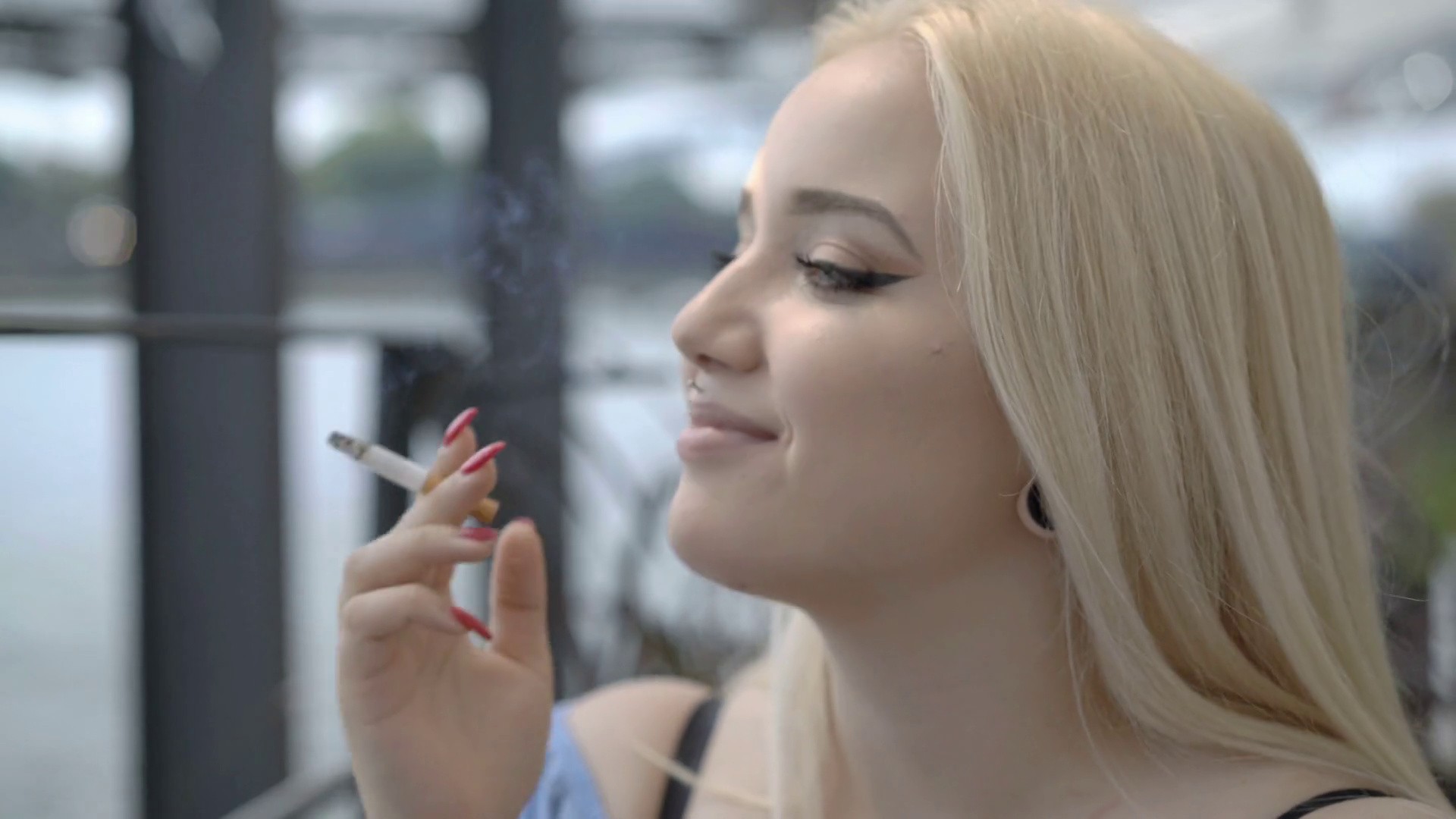 beautiful woman smoking cigarettes video Woman smoking cigarette while sitting on the boat and talking with someone