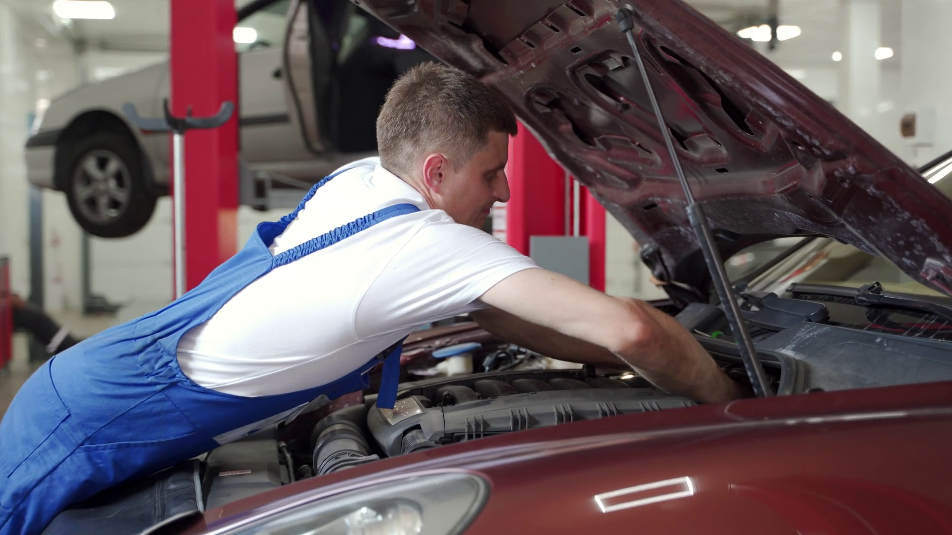 Mechanic In Blue Uniform Repairs Car Engine Stock Footage SBV-348938342 ...