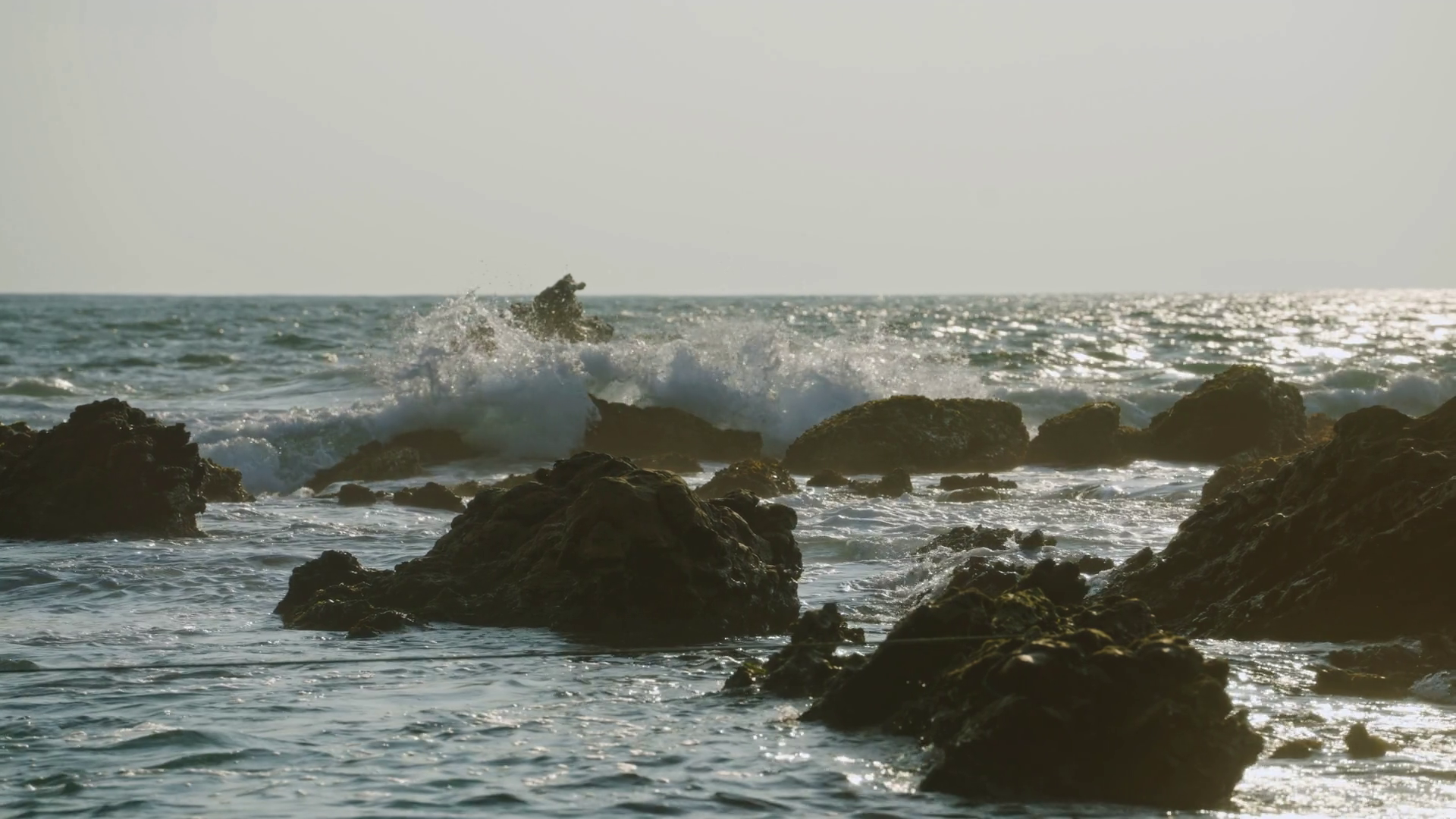 Waves Crash Against Rocks On Beach At Sunset Stock Footage SBV ...