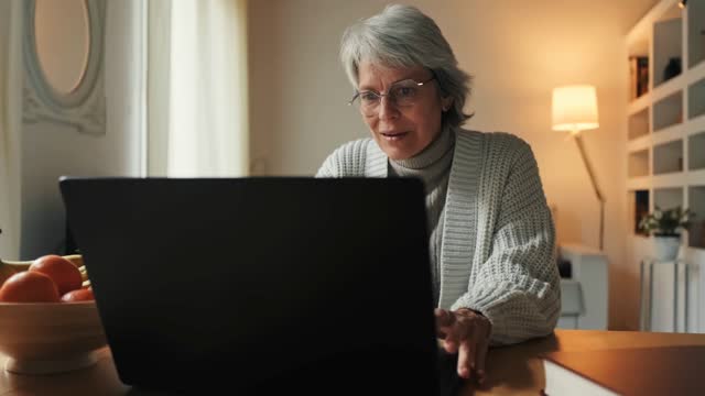 Woman Watching Video Laptop Stock Footage: Royalty-Free Video Clips ...