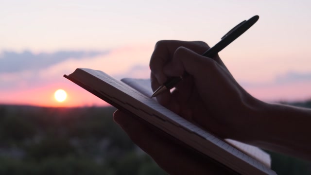 Person Journaling While Watching The Sunrise Stock Footage: Royalty ...