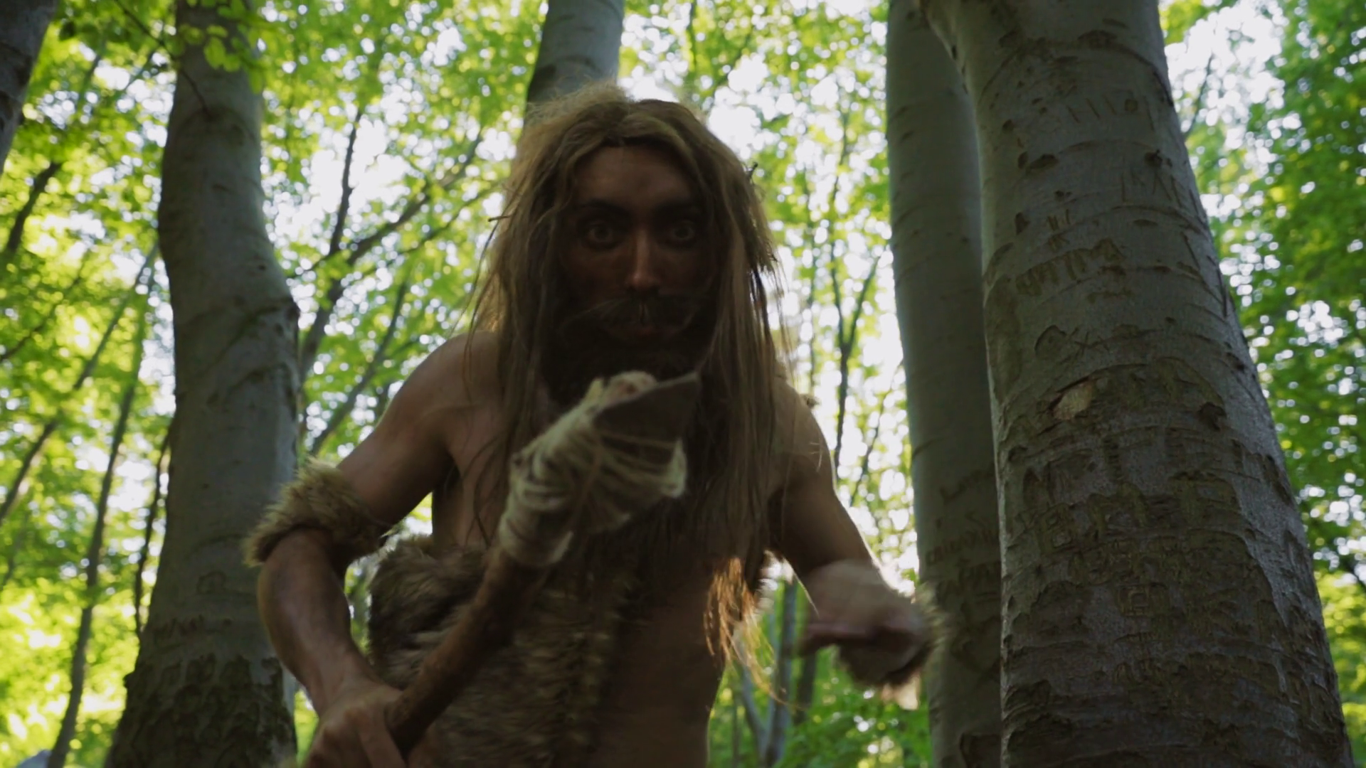 A Caveman Proudly Stands In Lush Forest Stock Footage SBV-351986712 ...
