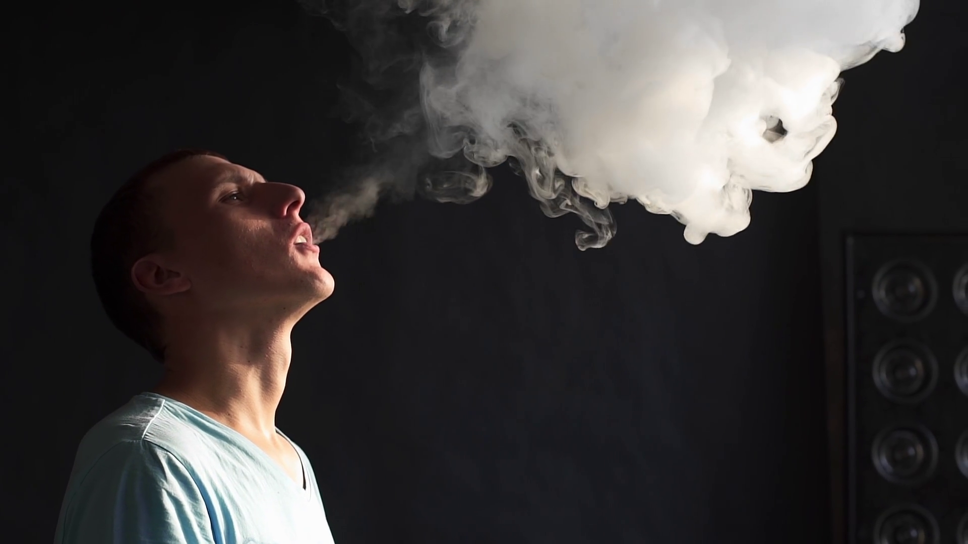 Man smokes electronic cigarette and and makes some smoke clouds, guy is  vaping, e-cig and vape pen, bad habbits of people