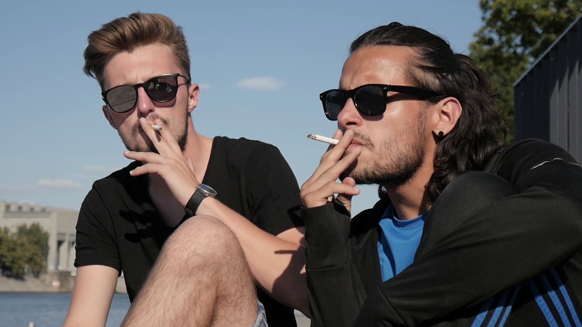 cigarette friends smoking together Two Friends Enjoying a Day by the City Quay