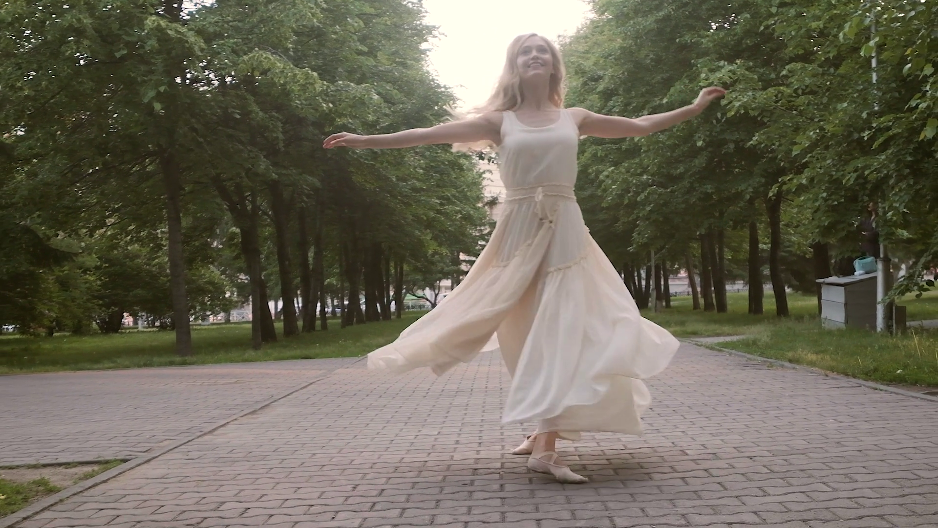 girl in a flowing dress dancing on the street.