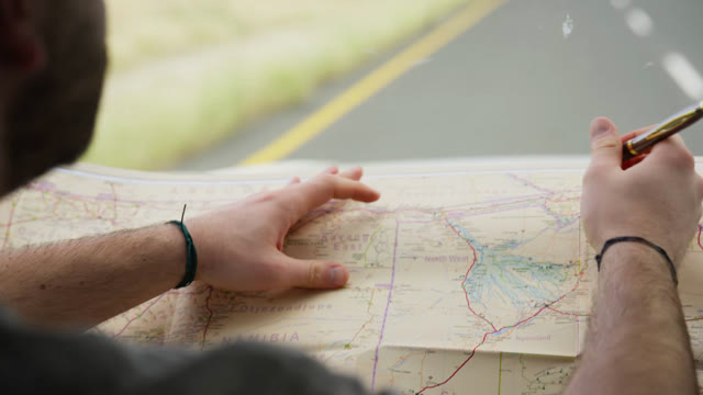 Traveler Planning Map Stock Footage: Royalty-Free Video Clips - Storyblocks