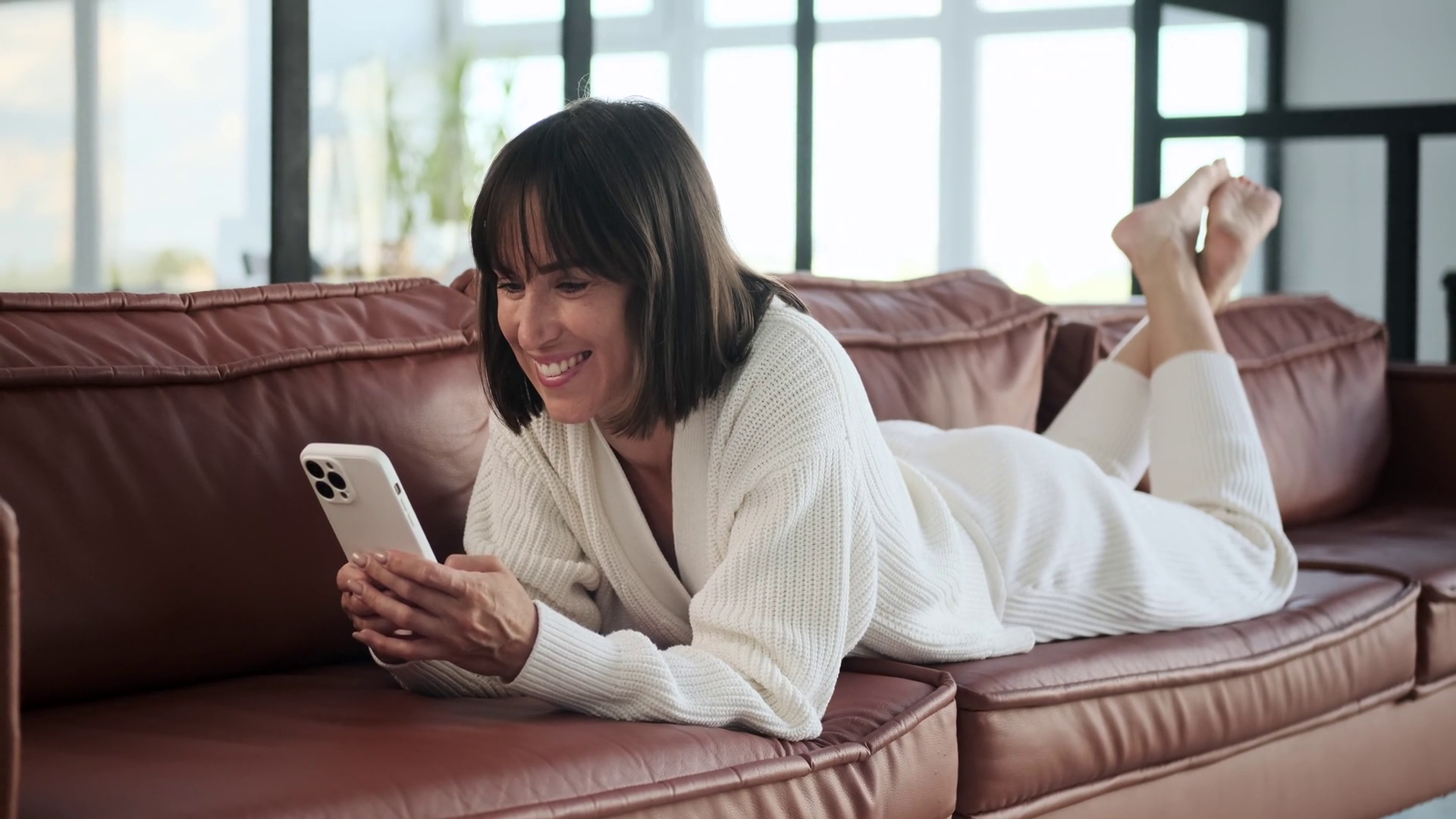 Smiling Woman Texting On Phone Lying On Sofa Stock Footage SBV ...