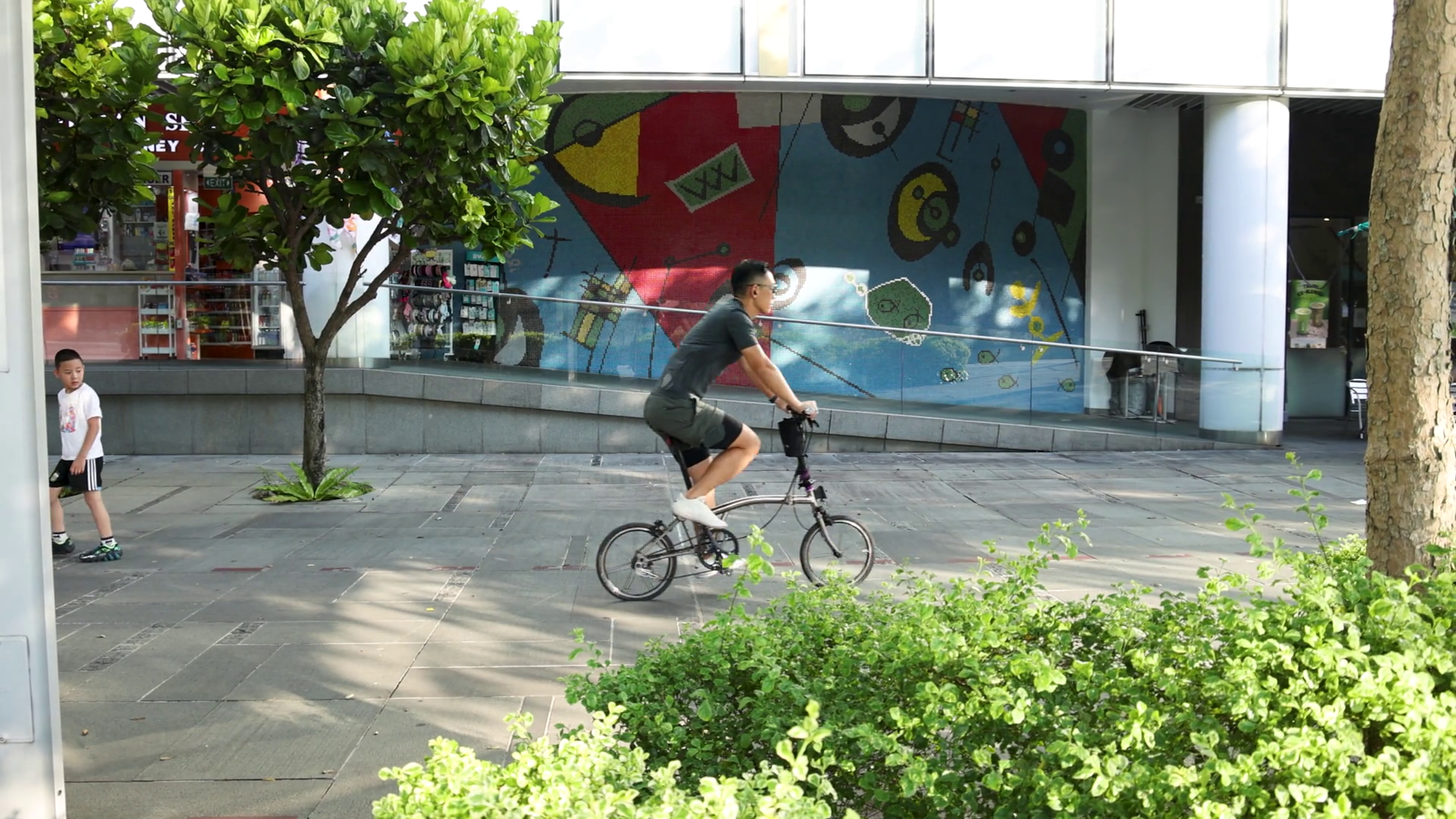 Man Riding Folding Bicycle Past Urban Mural Stock Footage SBV-352677039 ...