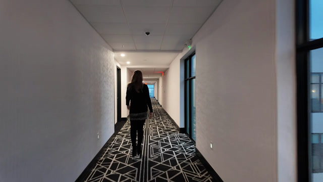 Woman Walking Down Hotel Hallway Stock Footage: Royalty-Free Video ...
