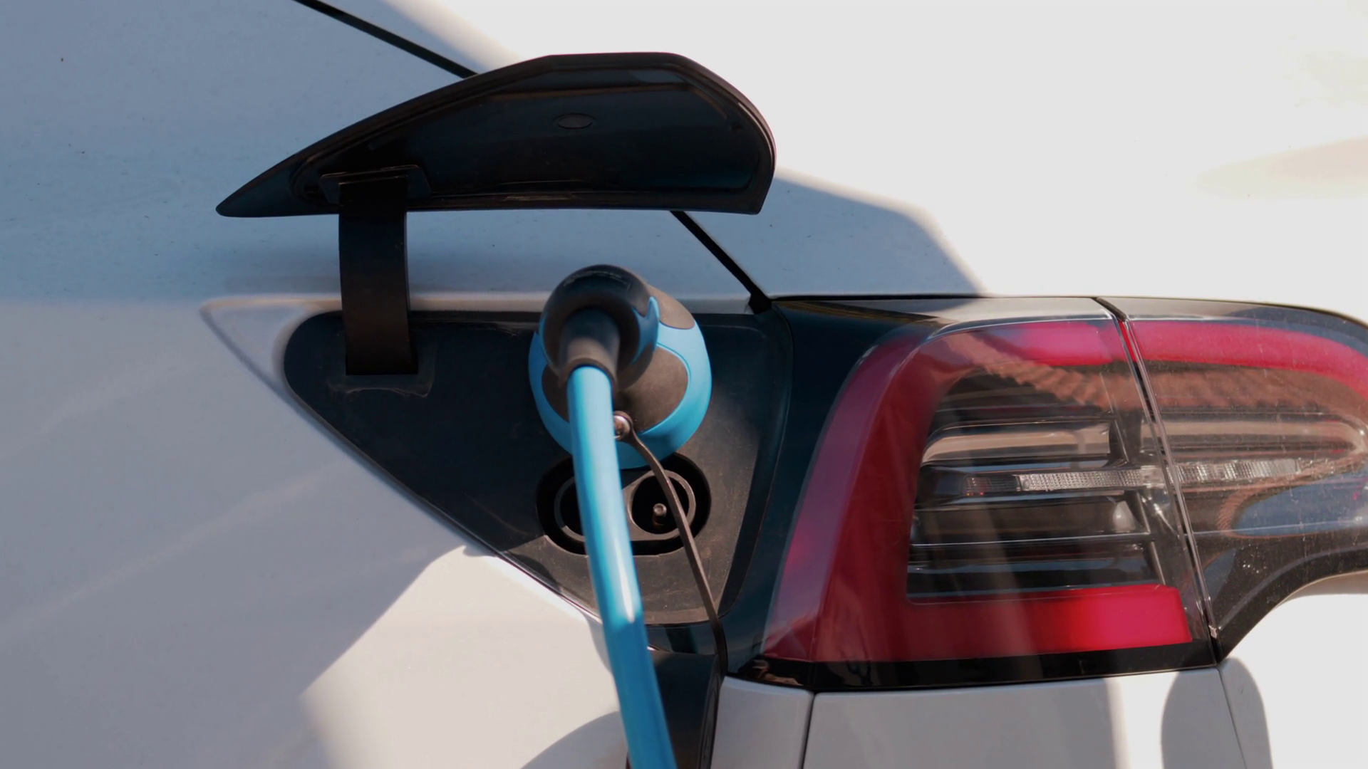 Close Up Of Electric Car Plugged Into Blue Stock Footage SBV-353113239 ...