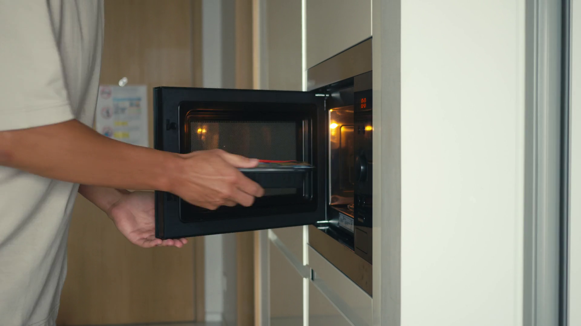 Man Reheating Leftover Meal Using Kitchen Stock Footage SBV-351916466 ...