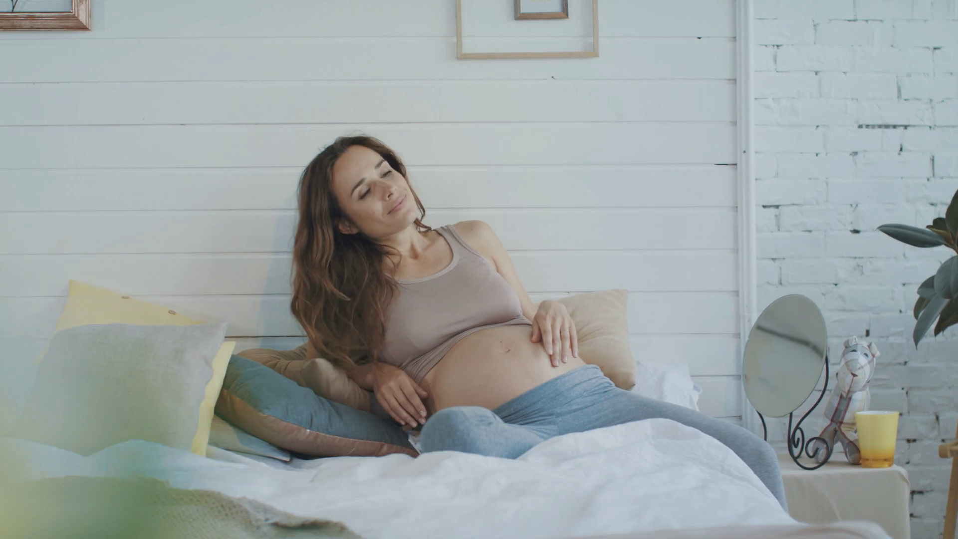 https://d2j2uxe7jasn0r.cloudfront.net/thumbnails/video/Vd3bj2jPe/videoblocks-beautiful-pregnant-woman-touching-her-belly-at-home-peaceful-belly-mother-lying-on-bed-pillows-in-bedroom-smiling-expectant-mother-resting-indoors_bx6xu2c-l_thumbnail-1080_08.png