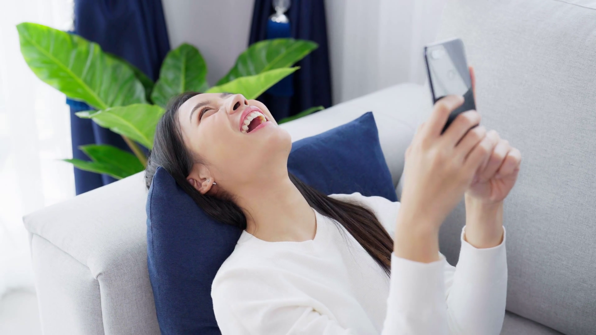 Young Woman Relaxing At Home Smiling On Sofa Stock Footage SBV ...