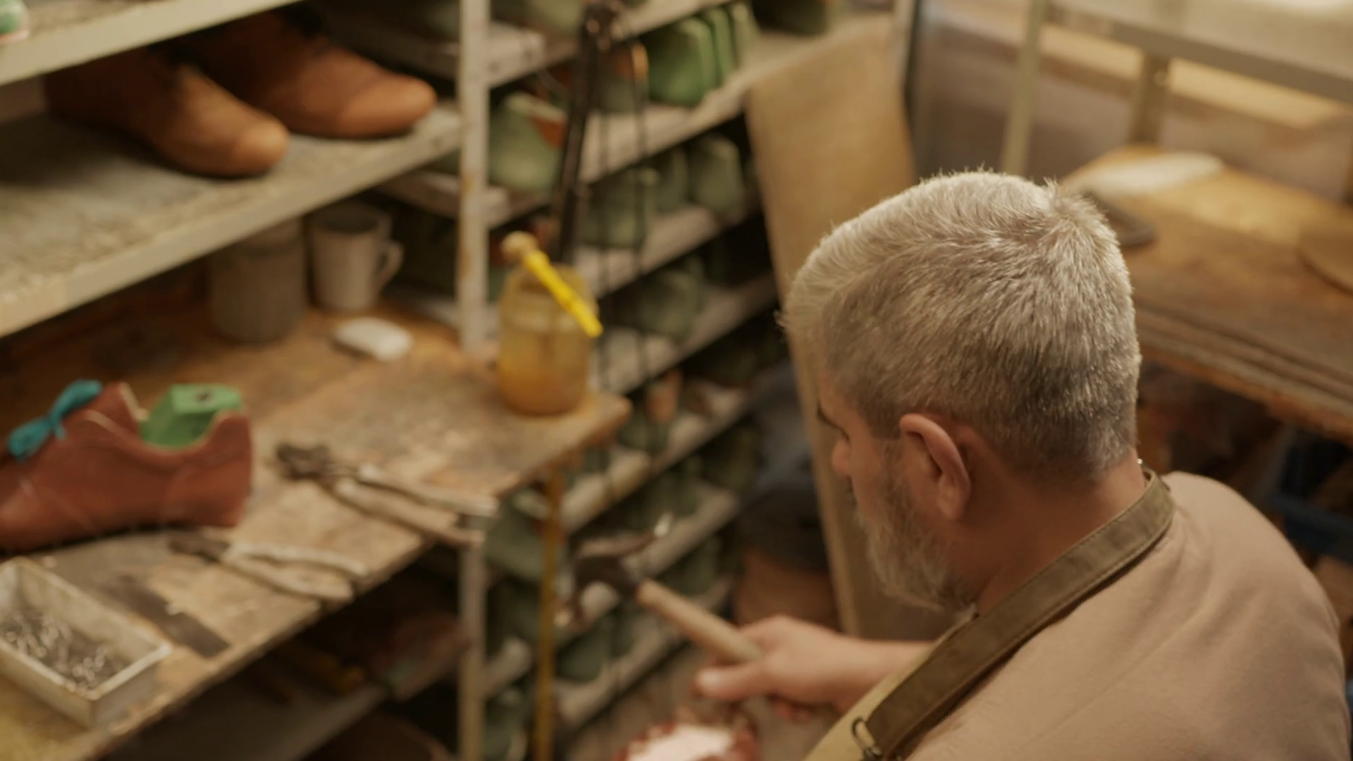 Over Shoulder Shot Of Senior Shoemaker Using Stock Footage SBV ...