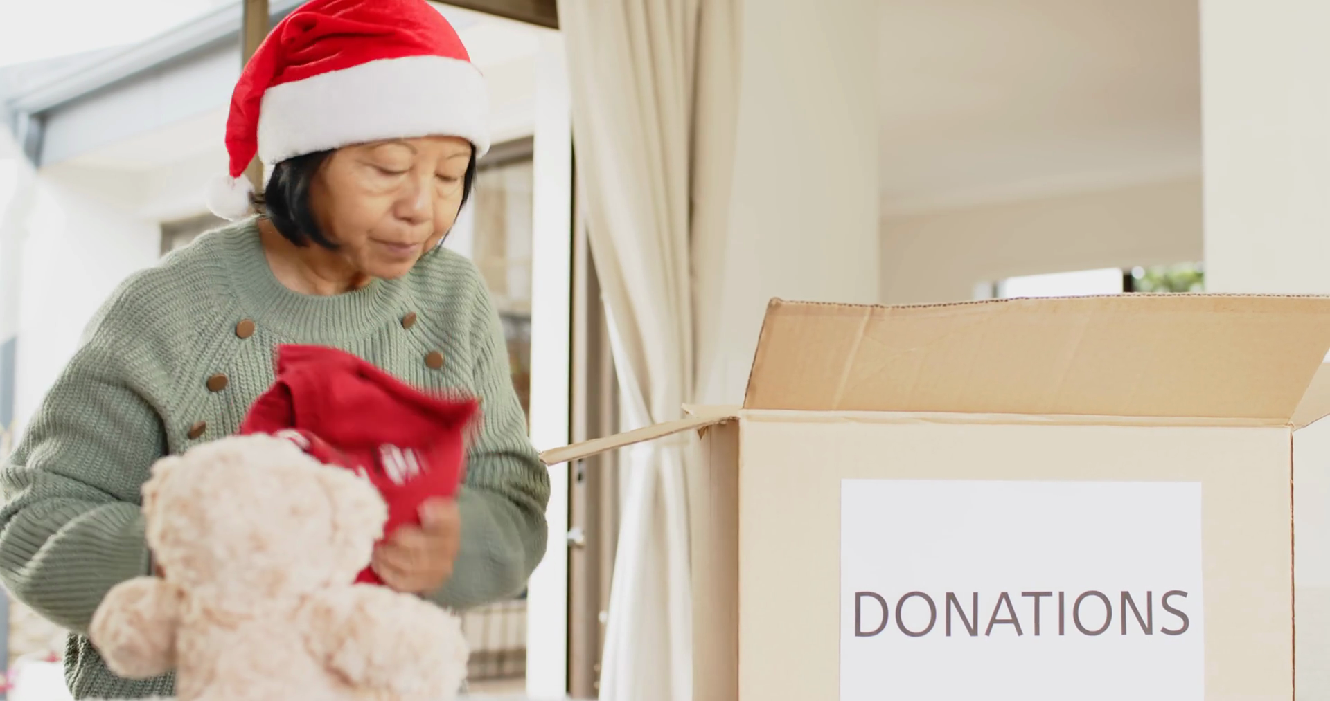 Elderly Woman In Santa Hat Donating Teddy Stock Footage SBV-349383724 ...