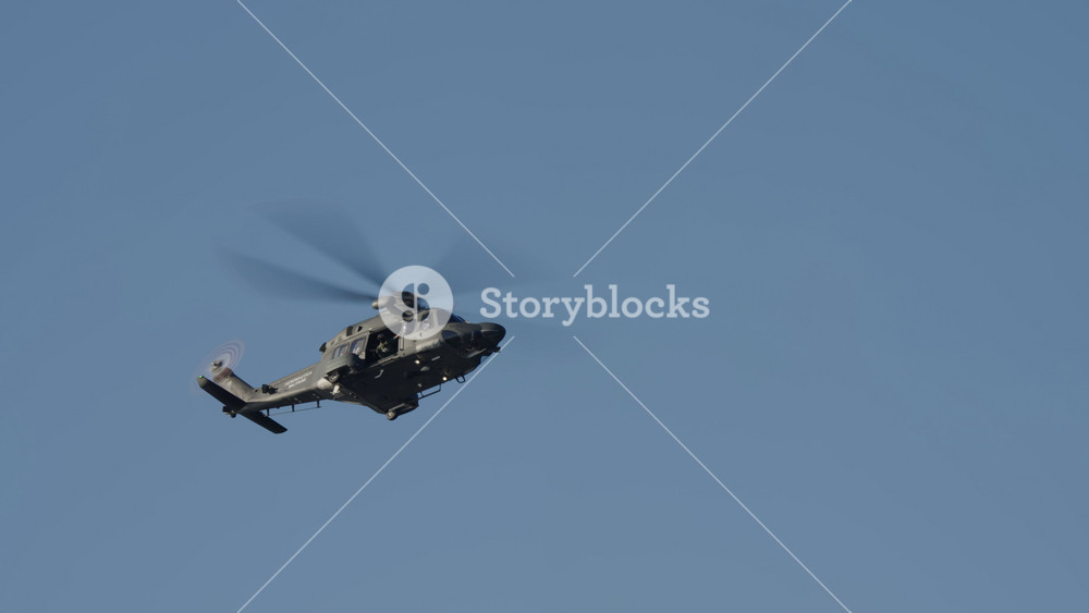 LUQA, MALTA - SEPTEMBER 28, 2025: Video footage of an Italian Air Force military helicopter flying past the camera. The dark grey chopper