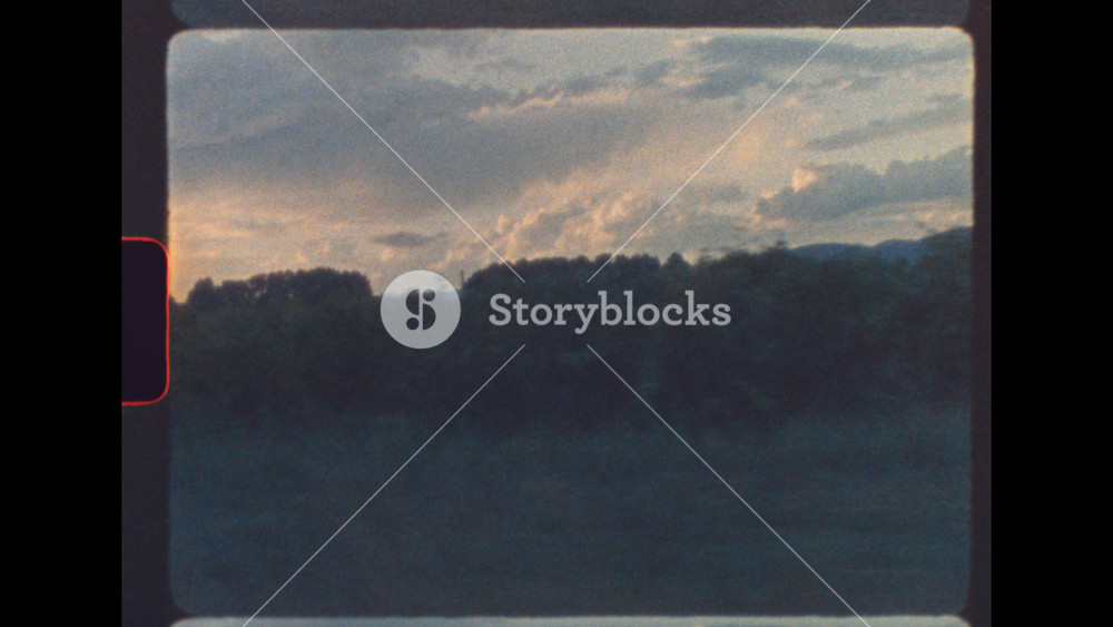 Vintage 8mm footage of French vineyard in Provence seen from moving car at golden hour with retro film grain and texture