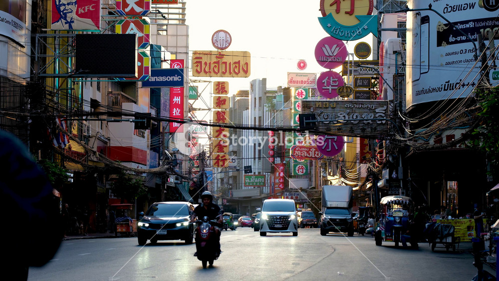 Bangkok, 20 November 2025, Chinatown as cars, cyclists, and locals fill the streets. Colorful signs and bustling shops create a unique urban