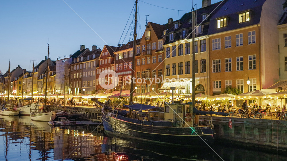 Copenhagen, Denmark. Zoom out evening shot of Nyhavn New Harbour with colorful houses and sailing boats in Copenhagen. 4K HDR shot