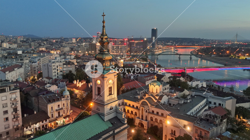 Sunset view of Belgrade with city lights. Flying over Cathedral of Saint Michael, Sava river, bridges and old town in Belgrade - capital of