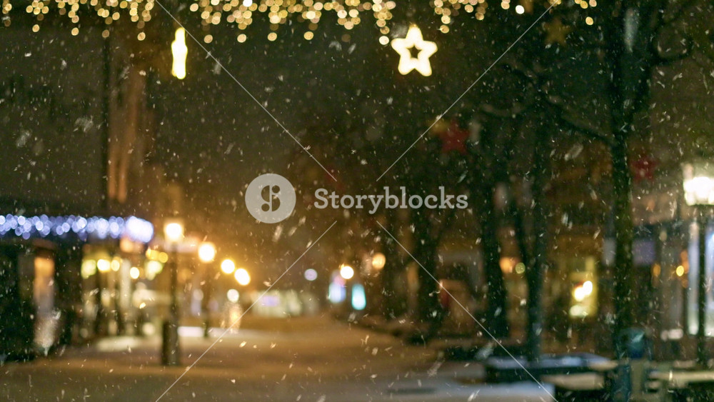 Christmas city lights illuminate snowy streets as festive atmosphere fills the air. Winter in the city. Cozy atmosphere of winter city