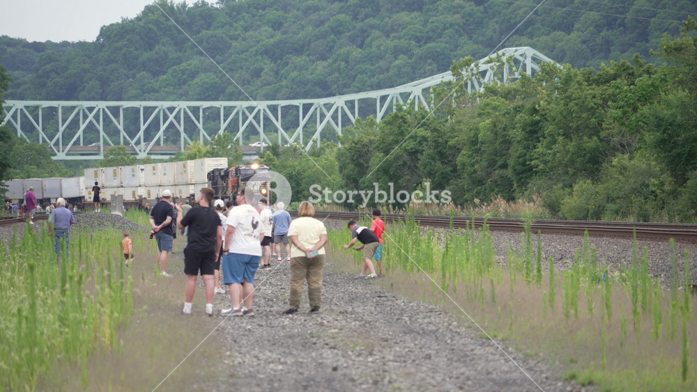 LEETSDALE, PA - July 11, 2026 - Railfans gather along the tracks in Pennsylvania as a Norfolk Southern intermodal freight train passes before the arrival of Union Pacific Big Boy Number 4014. 15236
