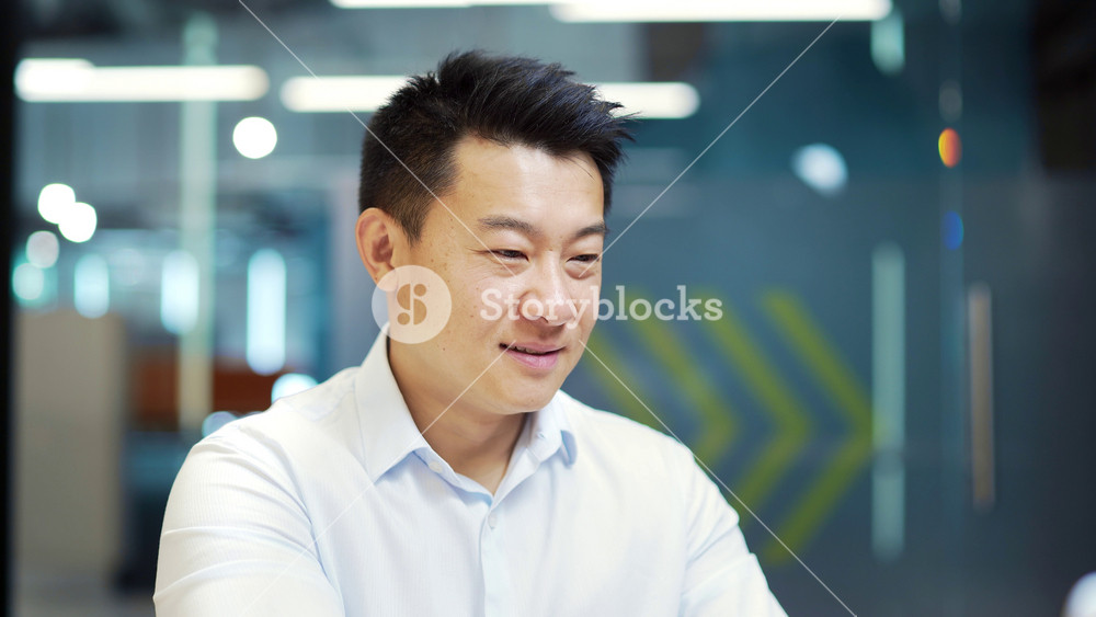 Portrait of happy asian male Employee businessman or accountant lawyer, notary, banker working on laptop computer smiling looking at camera sitting at desk in office. Business man manager at workplace