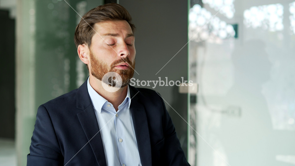 Businessman in a formal suit suffering from eye strain sitting at workplace in business office. A tired entrepreneur instills eye medicine to improve vision recommended by an ophthalmologist. Close up