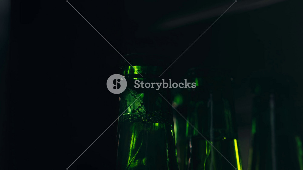 Row of beer bottles in fridge, shop or hotel, cold lager craft german beer or cider, shop supermarket or wine cooler close up.