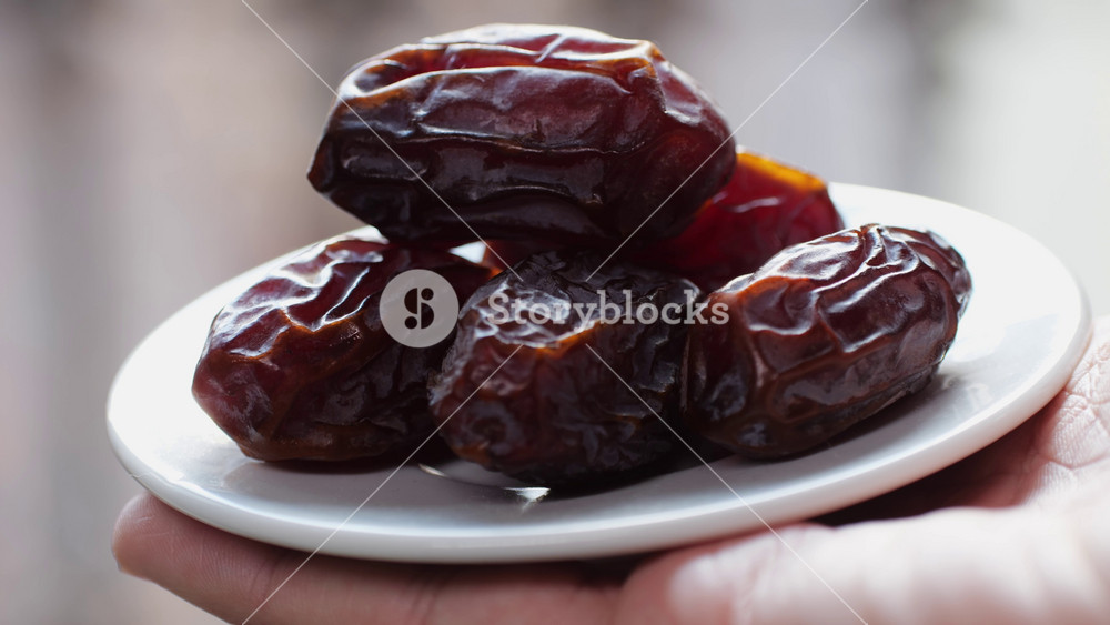 Fresh dates fruits close up on kitchen, close up in supermarket. Eating dried fruits. Vegan, vegetarian food.