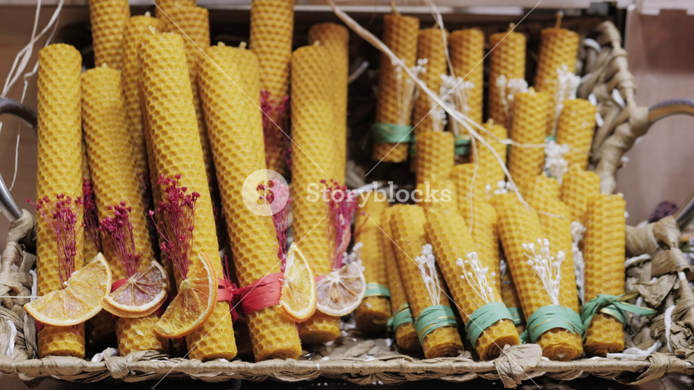 Christmas market with candles,toys, candies and decorations. Xmas goods and presents for sale. New Year decor with garland and wreath on