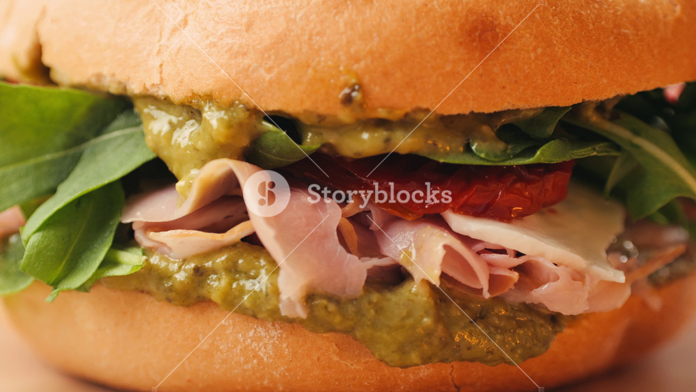 Mortadella ham sandwich, Traditional italian focaccia filled with thin pesto slices of mortadella, served by chef man in cafe restaurant