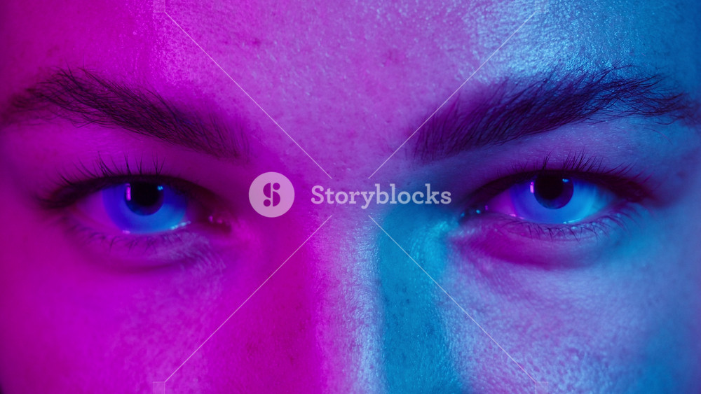 Close-up of young woman eyes wearing white decorative lenses in ultraviolet light. Advertising of protective contact colorful lenses for