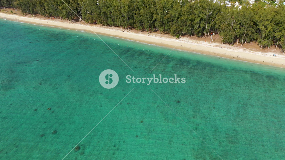Beautiful Mauritius island with beach Flic en flac. Coral reef around tropical palm beach, Flic en Flac, Mauritius. Aerial view of a beautiful beach along the coast in Flic en Flac, Mauritius.