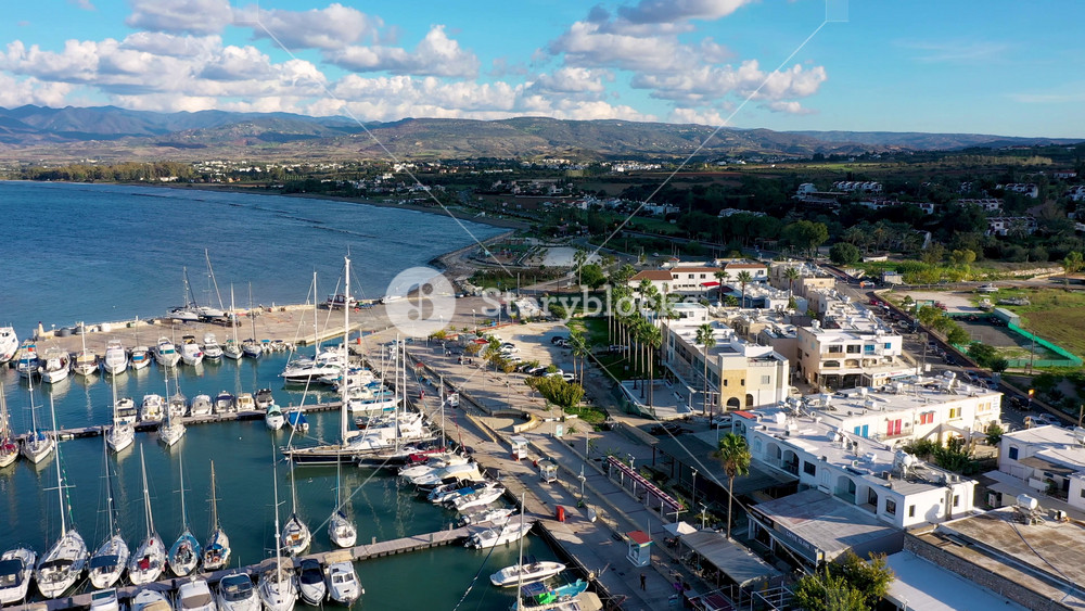 View of Latchi port, Akamas peninsula, Polis Chrysochous, Paphos, Cyprus. The Latsi harbour with boats and yachts, fish restaurant, promenade, beach tourist area and mountains, Latchi, Cyprus.