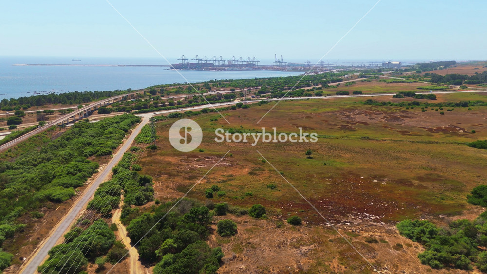 coastline near the Port of Sines and green landscape. Sines, Setubal, Portugal. Aerial view. Moving forward