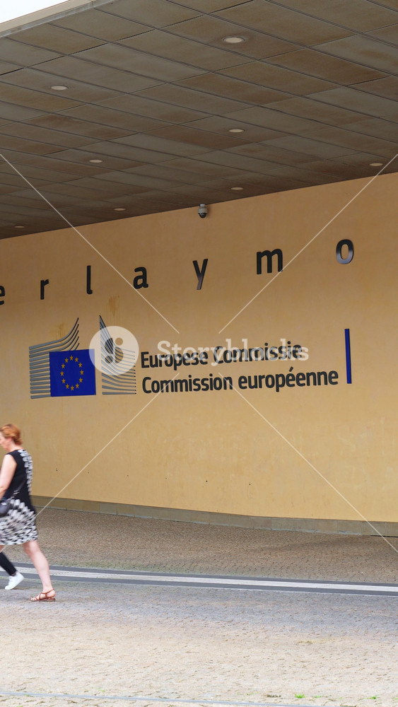 BRUSSELS, BELGIUM - JUNE 16, 2025: Entrance of the Berlaymont Building, Headquarters of the European Commission with Organization Logo. People Passing By. City of Brussels, Belgium. Vertical Video