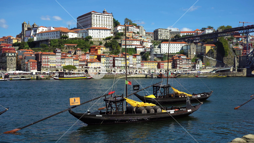 PORTO, PORTUGAL - SEPTEMBER 18, 2024: Porto City and Traditional Boats with Port Wine Barrels on Douro River on Sunny Day. Porto, Vila Nova