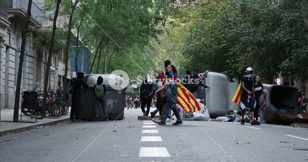 riot police clash with protestors at the general strike in via laietana, barcelona. the strike was called over the long prison sentences handed to the catalan politicians