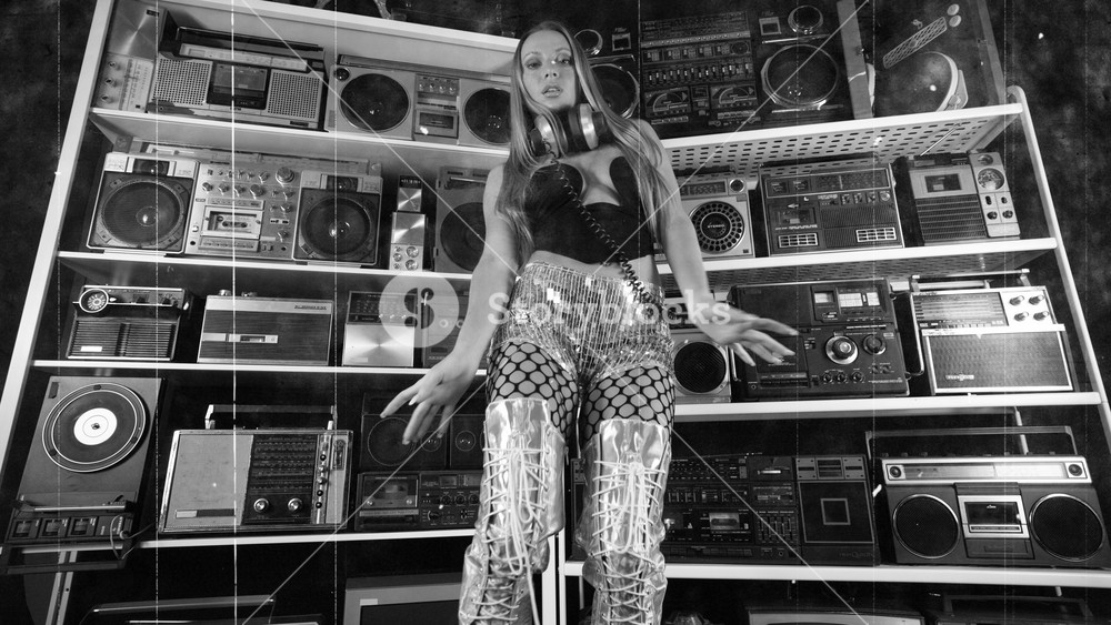 Amazing female dancer infront of a wall of amazing vintage boombox ghettoblasters and radios with an old film texture