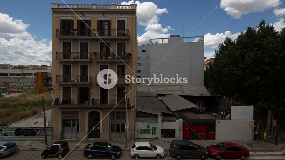 timelapse shot of an apartment building surround by derelict land in the poblenou district of barcelona