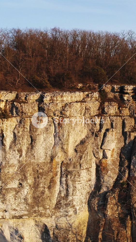 Panoramic landscape with rock cliff and christian cross on its peak. Shot. Concept of religion, place of faith and peace, aerial view of a
