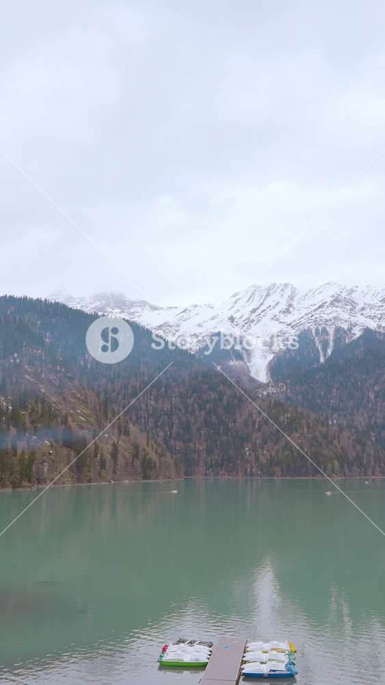 Breathtaking landscape with turquoise lake and green mountains. Action. Small sailing boats on azure water, concept of travelling.