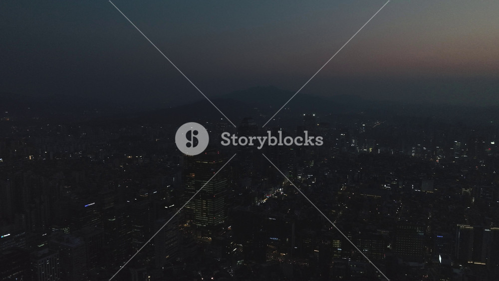 Aerial view of the glowing skyscrapers and busy city lights at night in Teheran-ro, Gangnam, Seoul, South Korea.