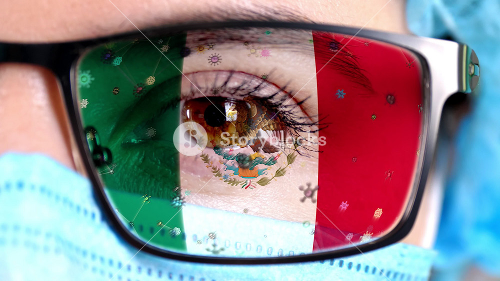 Mexican doctor in medical gear with flag glasses looking at microscopic threats. Government efforts in pandemic management and cure.