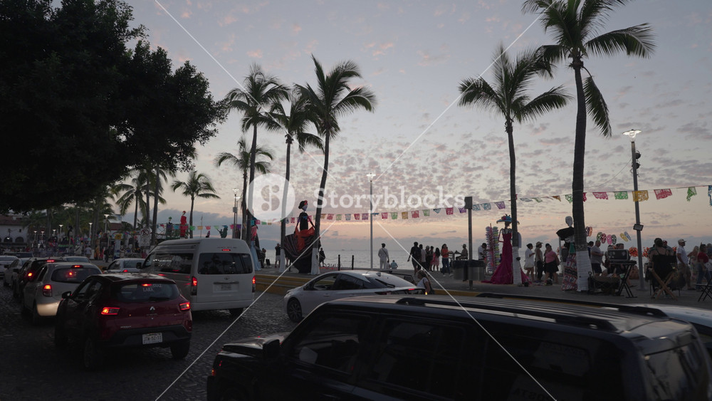 Puerto Vallarta, Mexico - November 1, 2024: The evening atmosphere Puerto Vallarta Malecón filled with La Calavera Catrina statues Day of the Dead Día de Muertos celebration