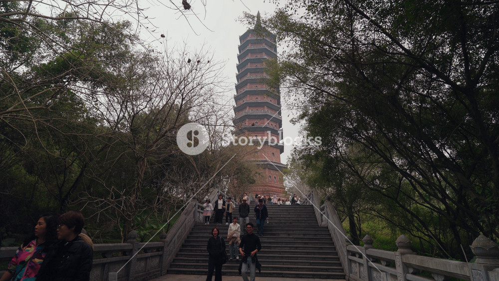Ninh Binh, Vietnam - February 1, 2026: Scenic view of a traditional pagoda roof at Ba Dinh Pagoda Complex in Hanoi, Vietnam, surrounded by trees and greenery, highlighting a peaceful cultural travel destination.