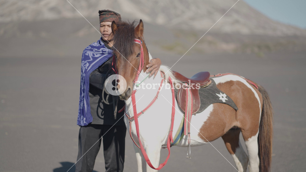 East Java, Indonesia - August 3, 2024: The Tengger tribe Tenggerese people native to Bromo Tengger Semeru highland Riding Horse at Sea of Sand