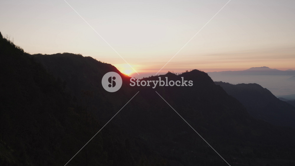 Bromo Tengger Semeru National Park located in East Java, Indonesia - beautiful panorama of five volcanoes and a sand sea in the caldera of the ancient volcano on a foggy day at sunset.