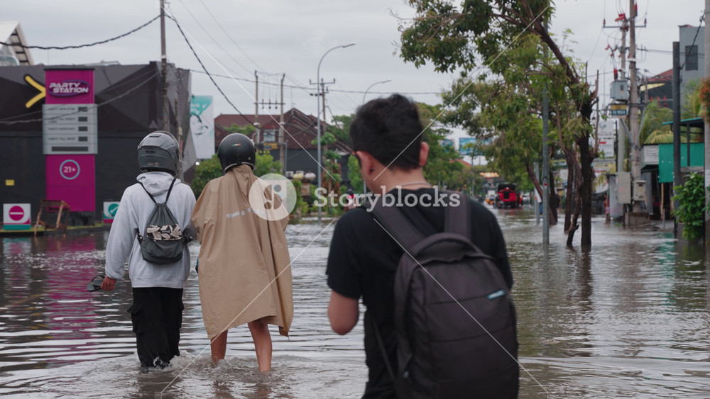 Bali, Indonesia - February 24, 2026: Flood conditions on Jalan Dewi Sri Kuta, Bali after heavy rain on Feb 24, 2026. Streets submerged with vehicles, pedestrians, and urban activity during severe flooding.